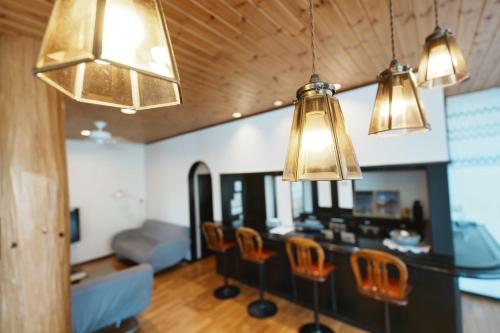 a living room with three lights and a table with chairs at SAMURISE No.4 in Fujikawaguchiko