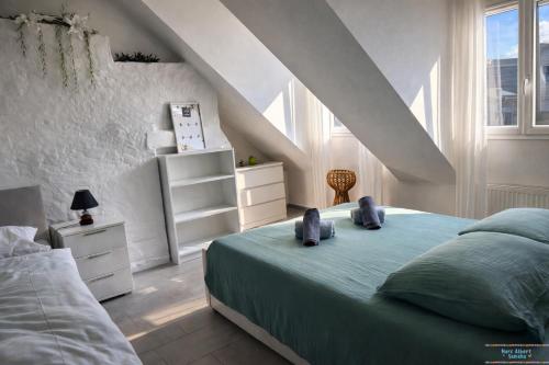 a white bedroom with a bed and a window at Hidden Gem Near the Moselle River in Grevenmacher