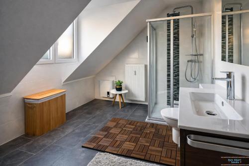 a bathroom with a sink and a shower and a toilet at Hidden Gem Near the Moselle River in Grevenmacher