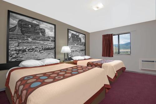 a hotel room with two beds and a window at Super 8 by Wyndham Taos in Taos