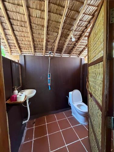a bathroom with a toilet and a sink at Lily's Riverhouse in Koh Rong Island