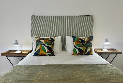 a bedroom with a bed with two lamps on both sides at Fisherman's Rest in Paternoster