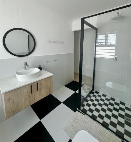 a bathroom with a sink and a mirror at Fisherman's Rest in Paternoster