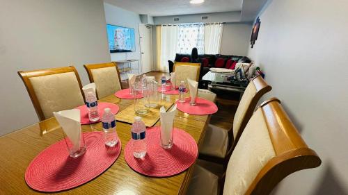 a dining room table with red plates and wine glasses at Full Privacy House with Free Parkrings in Toronto