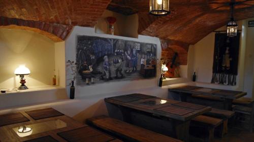 a room with benches and a painting on the wall at Folwark Hutta in Suwałki