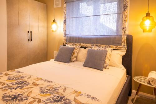 a bedroom with a large bed with a window at ELYMUS - Spacious 3-Bedroom Apartment With Private Rooftop and Balcony - Near Le Morne And Lagoon in La Gaulette
