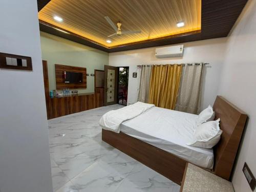 a bedroom with a bed in the middle of a room at Private Beach - Exotic Sea View Resort in Ganpatipule