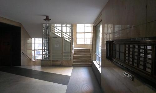 a hallway of a building with stairs and windows at Budanest Apartments in Budapest