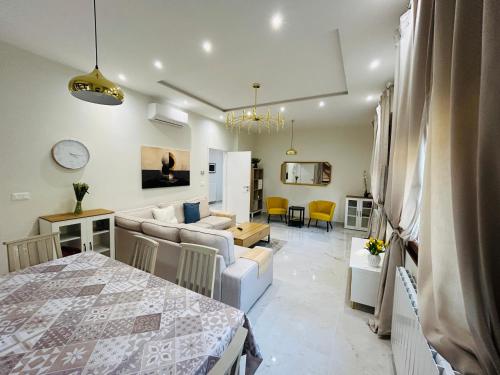 a living room with a couch and a table at Terme Boutique House in Montegrotto Terme