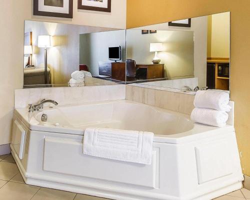 a large white bath tub in a hotel room at Comfort Inn Owatonna near Medical Center in Owatonna