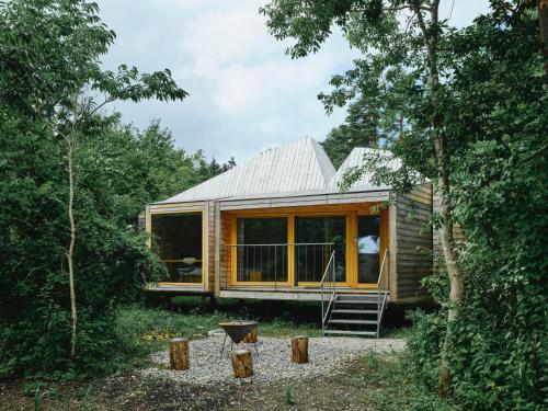 a cabin in the woods with a large window at SANU 2nd Home 河口湖2nd in Fujikawaguchiko
