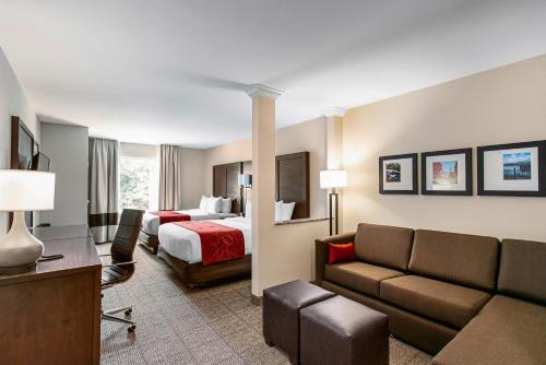 a hotel room with a bed and a couch at Comfort Suites Fishkill near Interstate 84 in Fishkill