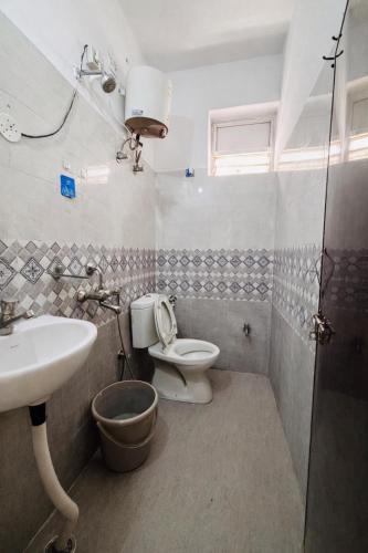 a bathroom with a toilet and a sink at Deccan Homes Kondapur in Hyderabad