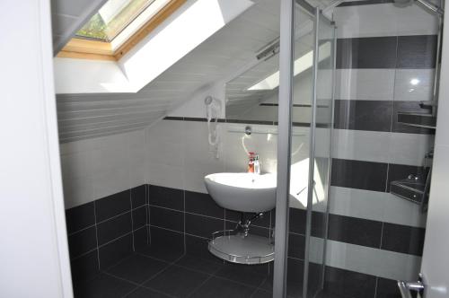 a bathroom with a sink and a glass shower at Garni San Paolo in Appiano sulla Strada del Vino