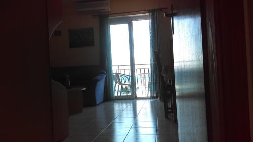 a hallway with a door open to a balcony at Apartment Sunce in Crikvenica