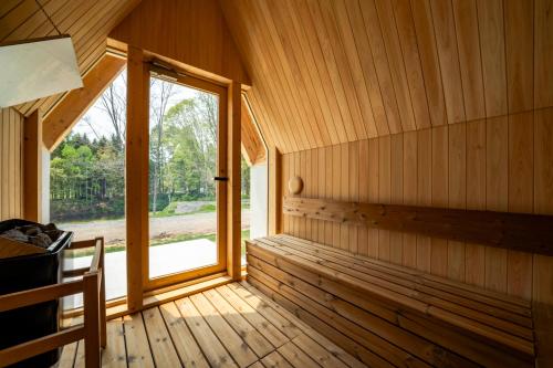 an empty room with a window in a wooden cabin at ERUSA Rusutsu in Rusutsu