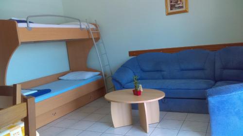 a small room with a couch and a bed and a table at Apartment Sunce in Crikvenica