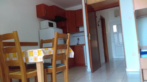 a small kitchen with a table and two chairs at Apartment Sunce in Crikvenica