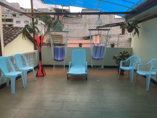 a group of blue chairs sitting on a patio at Hostal y Complejo Recreacional La Playita de Monse in Otavalo