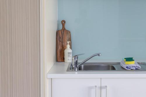 a kitchen counter with a sink and a bottle of soap at Bay View - Ocean Nest in Lorne