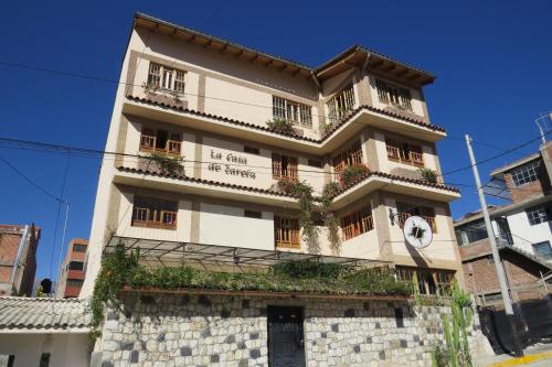 a building with a clock on the side of it at La Casa de Zarela in Huaraz