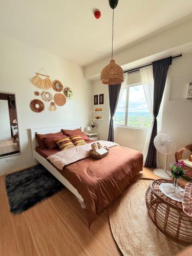 a bedroom with a large bed and a large window at Baan Mai Condo Staycation in Biñan