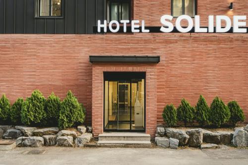 a hotel building with a hotel collective sign on it at Hotel Solide Cheonan in Cheonan
