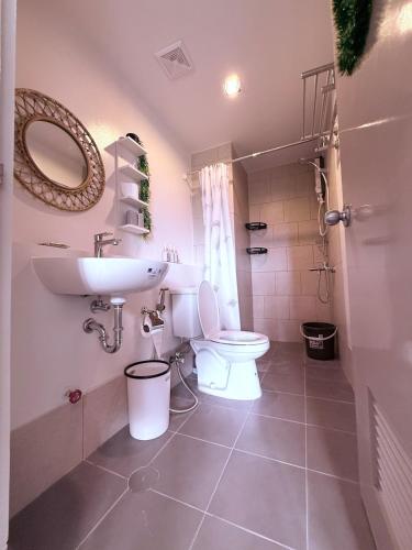 a bathroom with a toilet and a sink at Baan Mai Condo Staycation in Biñan