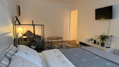 a bedroom with a bed and a tv on the wall at Church Hill Apartment in Daugavpils