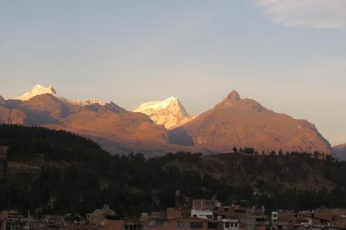 a mountain range with a city in front of it at La Casa de Zarela in Huaraz