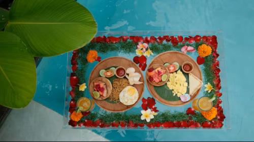 a table with two plates of food on it at Prana Ubud in Tegalalang