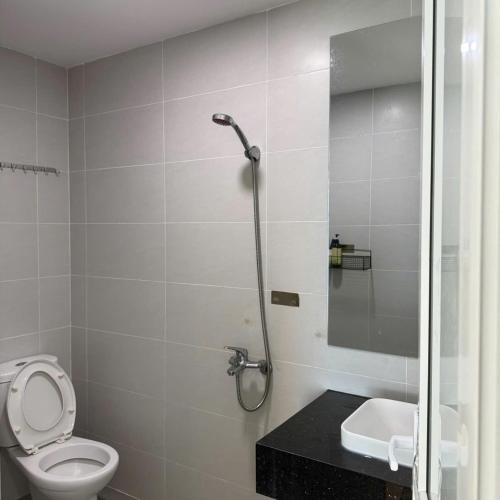 a bathroom with a shower with a toilet and a sink at TA Nhatrang Apartment in Nha Trang