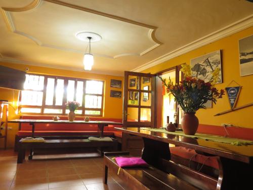 a living room with yellow walls and a table at La Casa de Zarela in Huaraz