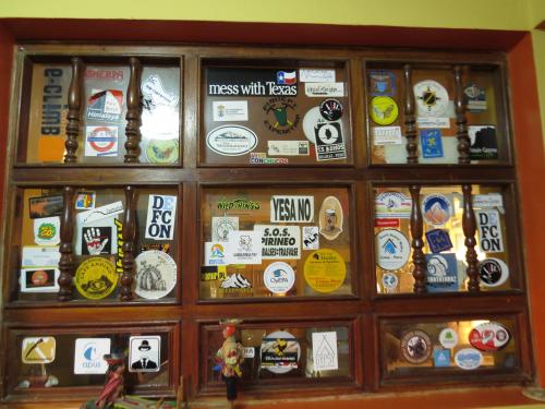 a display case filled with lots of stickers at La Casa de Zarela in Huaraz