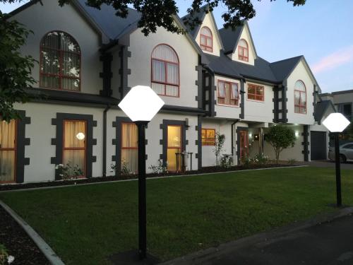 a house with three lights on the lawn at ASURE Destiny on Fitzherbert Motel in Palmerston North