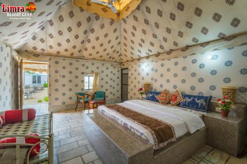 a bedroom with a large bed in a room at Limra Desert Camp With Swimming pool in Jaisalmer