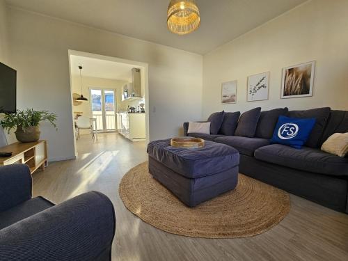 a living room with a couch and a table at Küstenglück 2 Stylisches Apartment mit Meerblick - 200m zum Strand & Bäcker in Dahme