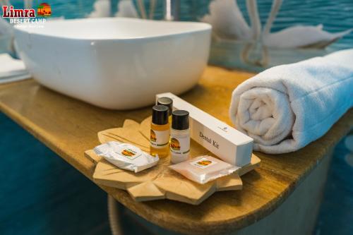 a table with two bottles of essential oils and a bowl at Limra Desert Camp With Swimming pool in Jaisalmer