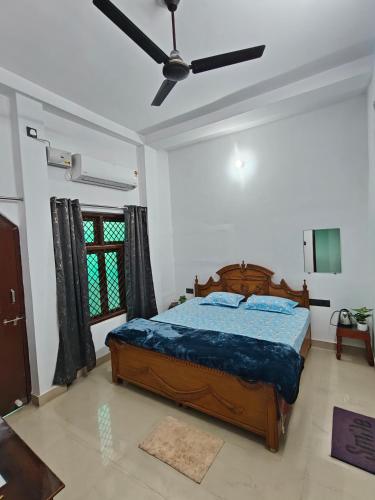 a bedroom with a bed and a ceiling fan at Shivprasad homestay in Varanasi