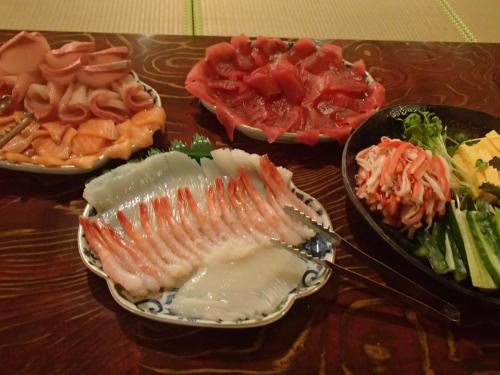 a table topped with different types of seafood and vegetables at Rosenheim Hakuba in Hakuba