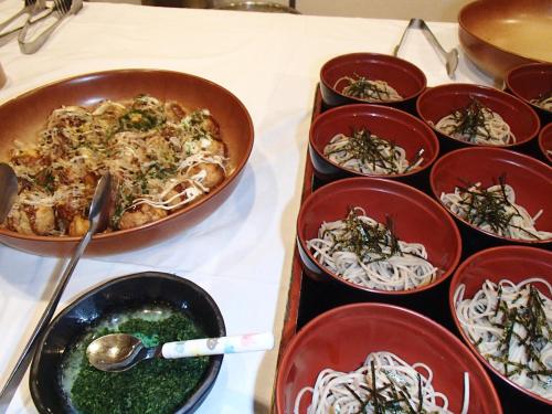 a table with bowls of food on a table at Rosenheim Hakuba in Hakuba