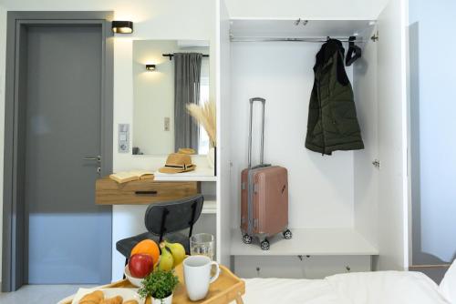 a room with a suitcase and a table with fruit at Coastline 1 in Perea