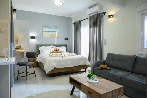 a bedroom with a bed and a living room with a couch at Coastline 1 in Perea