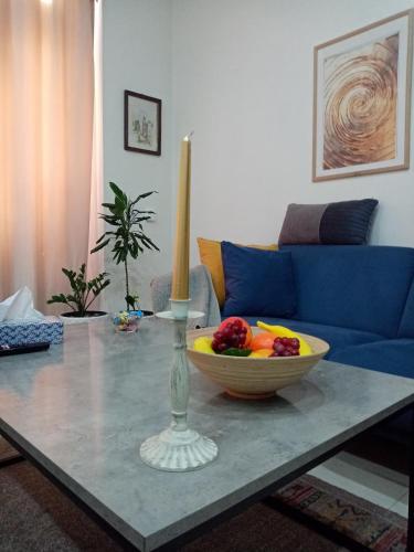 a living room with a table with a bowl of fruit on it at Sava & Double Rooms in Prijedor