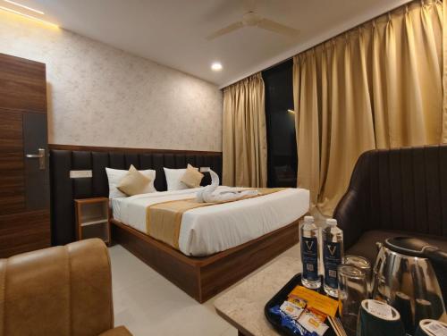 a hotel room with a bed and a couch at Hotel Vamshi Grand in Lingampalli