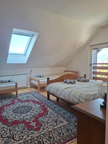 a bedroom with two beds and a rug at Villa Sabic - Free Garage & Panoramic View in Sarajevo