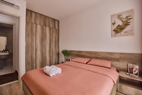 a bedroom with a bed with two towels on it at HongHome Compass One in Ga Phú Văn