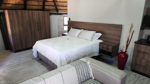 a hotel room with a bed and a couch at Bootleg Inn in Welkom