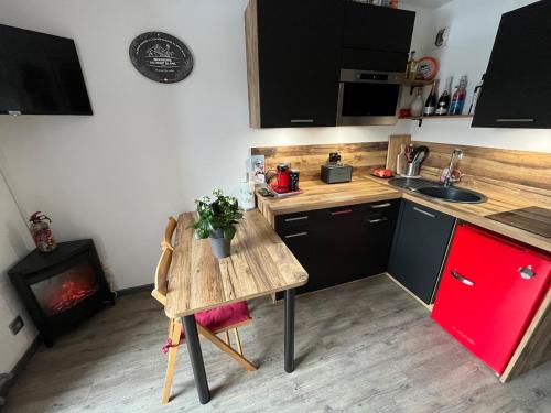 a small kitchen with a table and a stove at Ada & Cimes in Bourg-Saint-Maurice