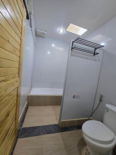 a bathroom with a toilet and a shower at Avatar Resort Phangan Thailand in Ban Nua